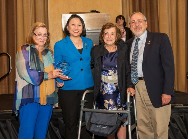 Dr. Jeffers (second from left) receives an EIM award from AMAF President Dr. Nancy Mueller (left), Rima Cabbabe (second from right) and Dr. Edmond Cabbabe (right)