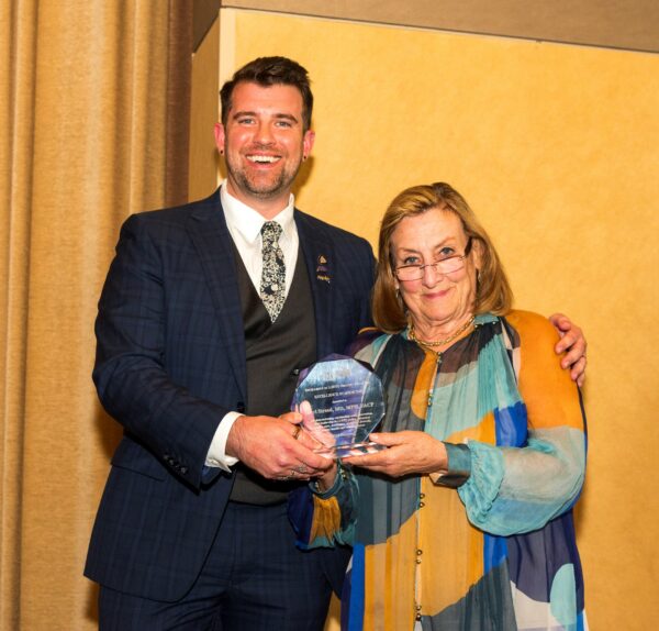 Dr. Streed receives an Excellence in Medicine Award from AMAF President Dr. Nancy Mueller