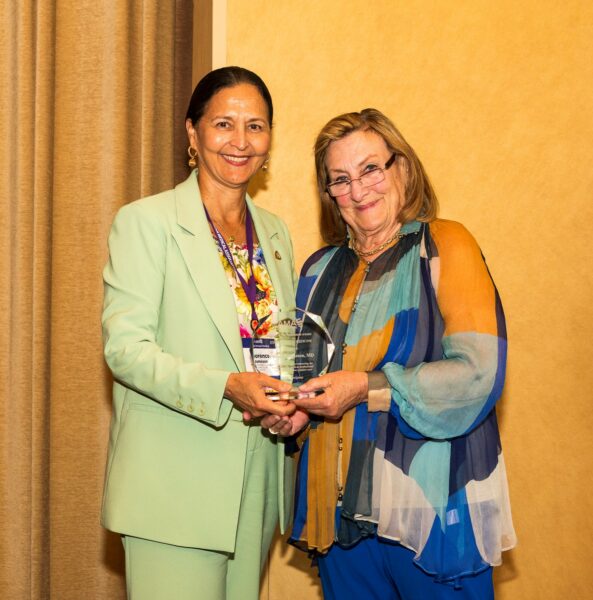 Dr. Jameson receives an Excellence in Medicine Award from AMAF President Dr. Nancy Mueller