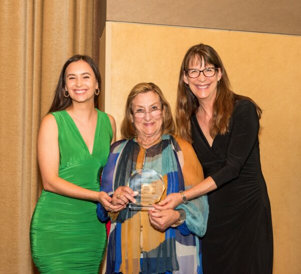 Dr. Heffron's daughter and granddaughter receive an Excellence in Medicine Award from AMAF President Dr. Nancy Mueller on his behalf