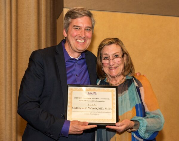 Dr. Wynia receives an Excellence in Medicine Award from AMAF President Dr. Nancy Mueller